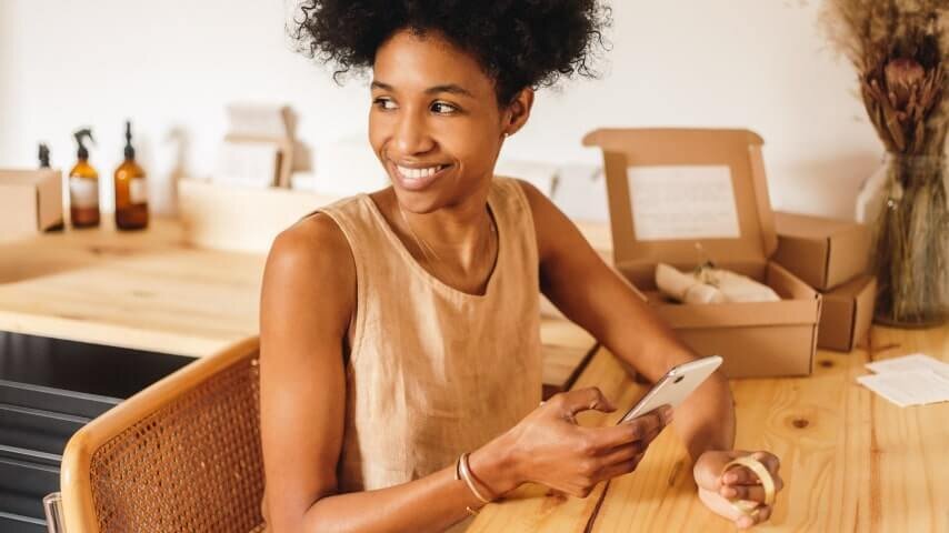 A woman packaging personalized orders.