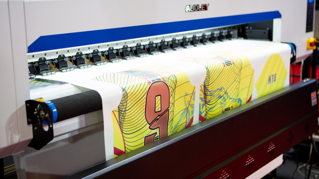 A sublimation printer with a print of a colorful all-over-print (AOP) design.