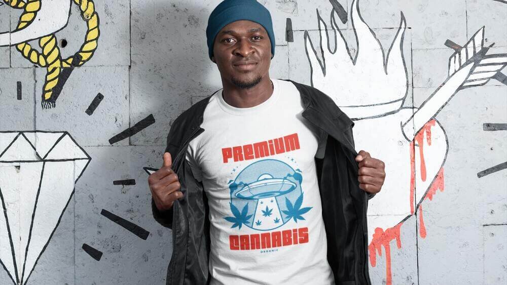 A man wearing a custom white Delta 11730 t-shirt with a “Premium Cannabis” print.