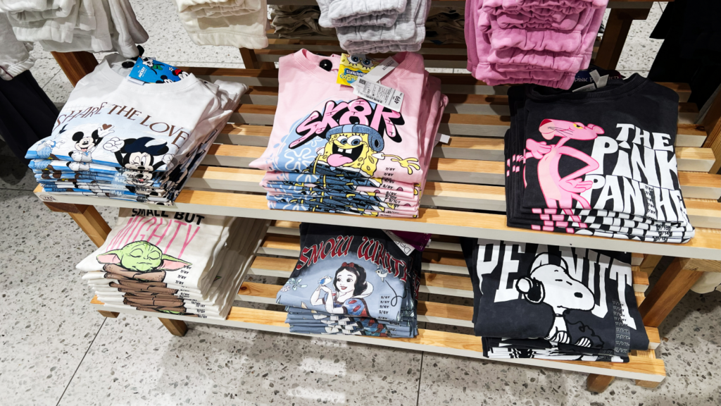 A display rack featuring various shirts, each showcasing unique designs and colors.