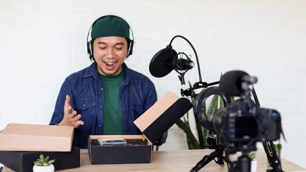 A young man unboxing his podcast merch.