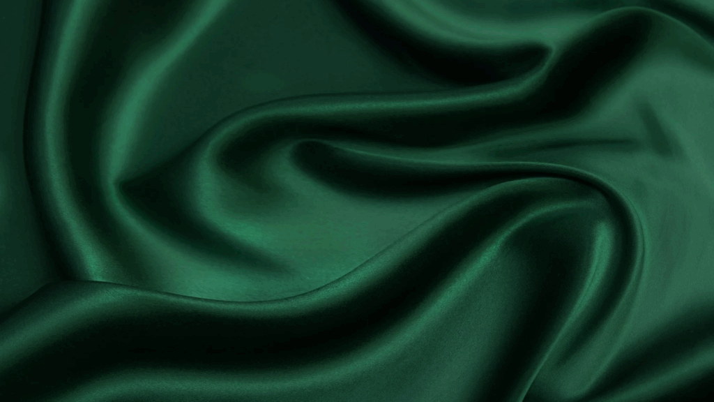 Close-up of dark green silk with a visible weave pattern.