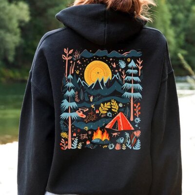 Black hoodie with a design on the back of a stylized camping scenery.