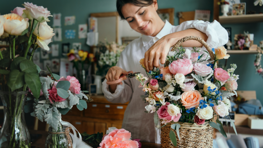 A florist creating a custom bouquet of flowers.