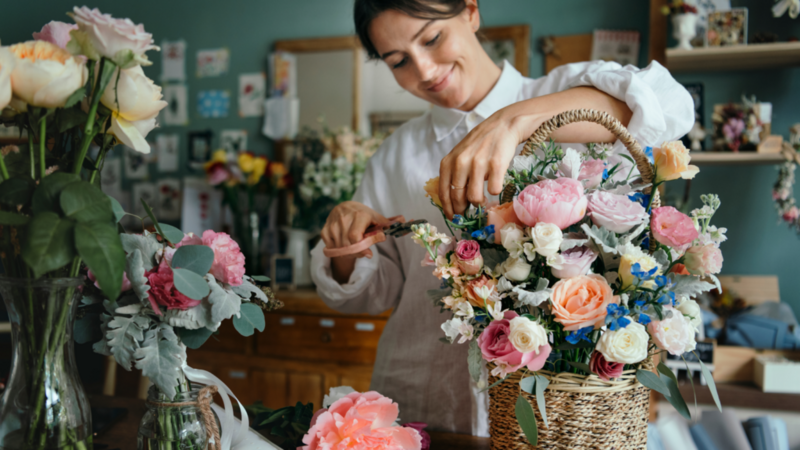 A florist creating a custom bouquet of flowers.