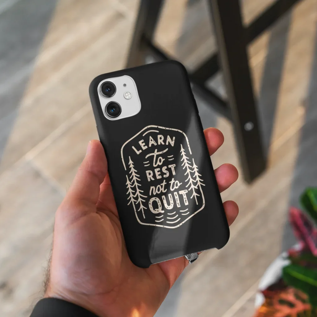 A custom black phone case with a “Learn to rest not to quit” print with illustrations.