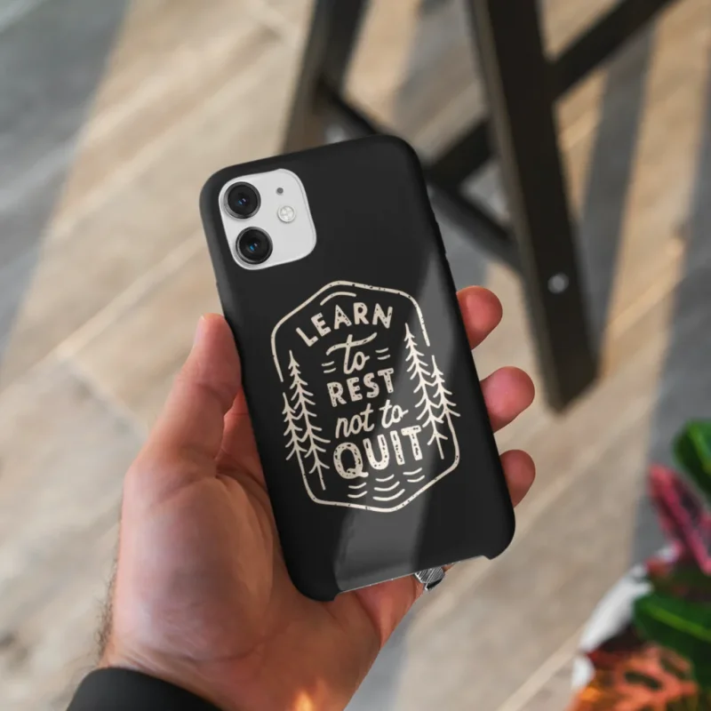 A custom black phone case with a “Learn to rest not to quit” print with illustrations.