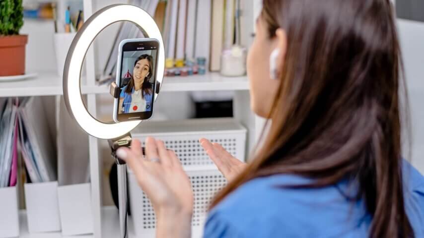 An influencer filming a TikTok video.