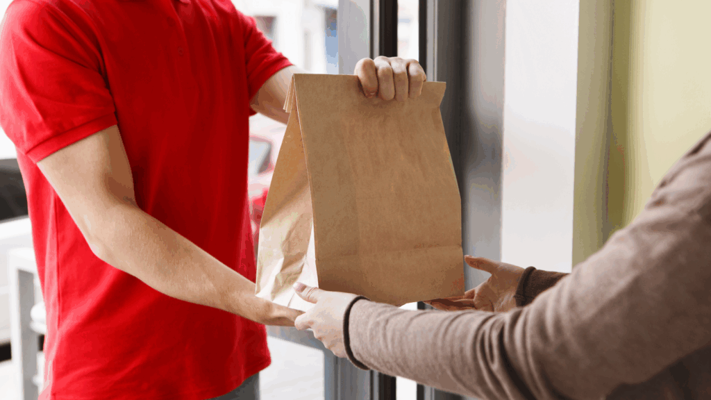 A courier delivering an order to the person.