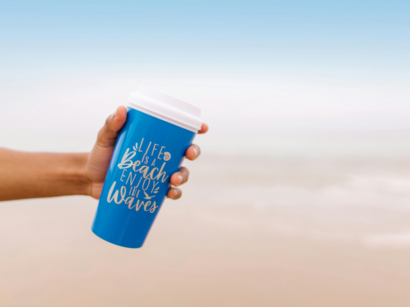 TravelMugs: A hand gripping blue travel mug mockup, showcasing its sleek design and vibrant color against a neutral background.