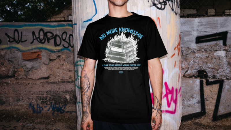 A man wearing a black t-shirt with the text "NO MORE KNOWLEDGE" and a graphic design of a stack of books on fire.