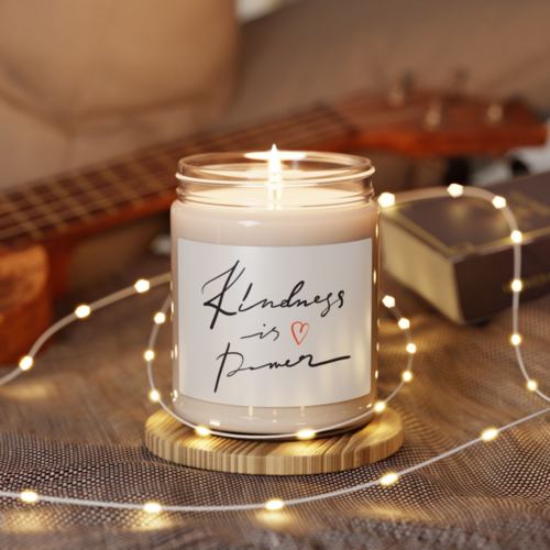 A custom eco-friendly print-on-demand soy candle with a “Kindness is power” sticker.