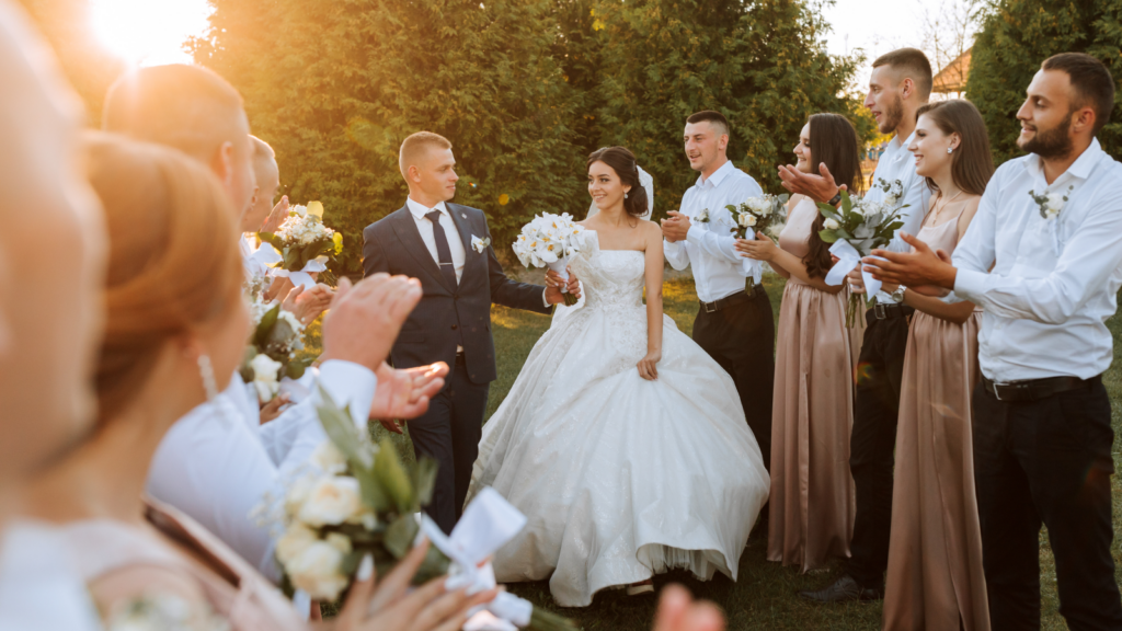A picture of a wedding with the groom, bride, and guests.