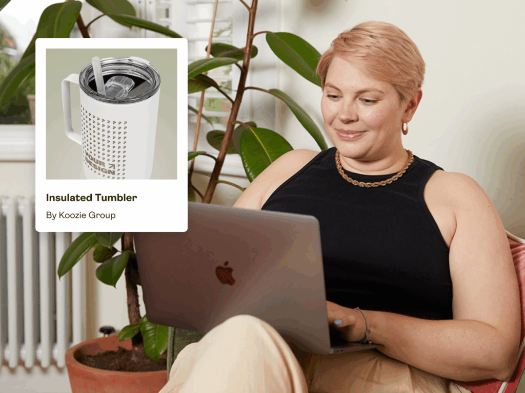 A woman is sitting in a chair and using a laptop to order engraved products with print-on-demand.