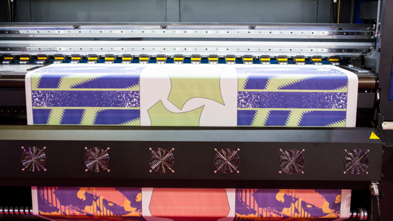 A direct-to-film DTF) printe in the process of printing.