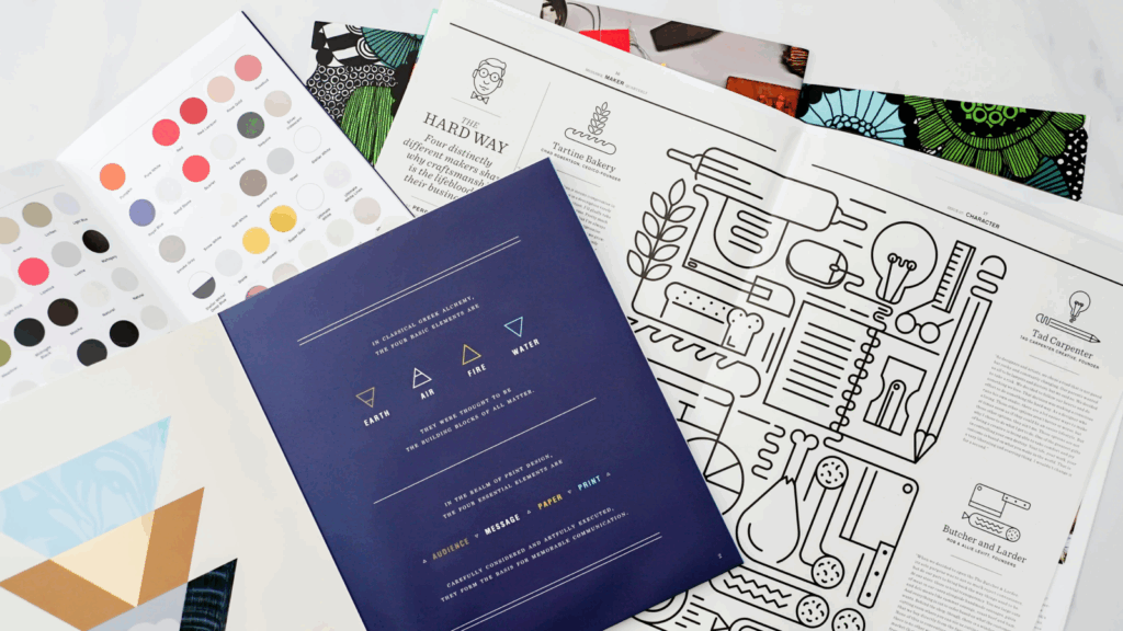 A book featuring a variety of colored papers and unique designs throughout its pages.