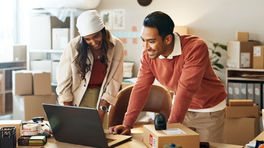 A couple of online store owners tracking and managing their stock.