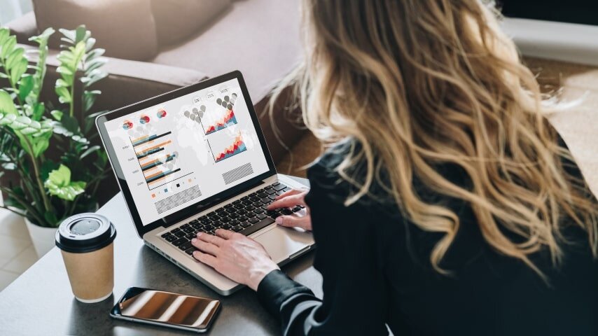 A woman performing marketing activities using a laptop.