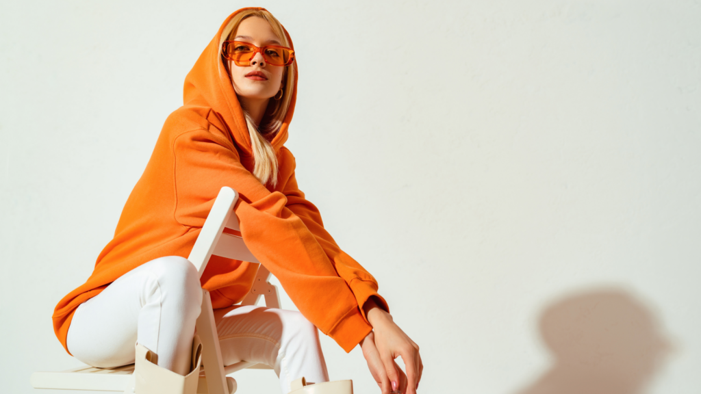A woman in an orange hoodie.