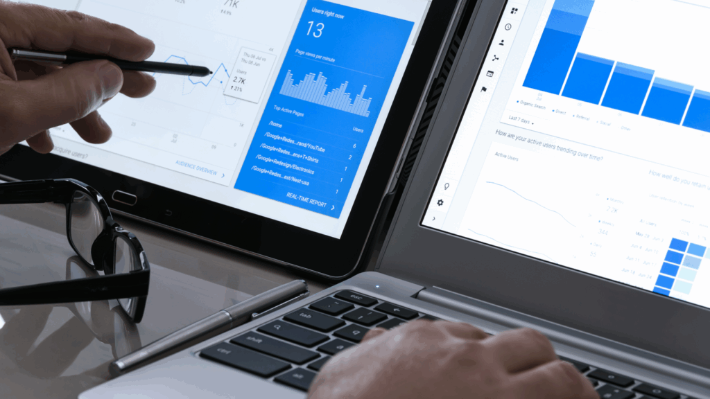 A person is working on a laptop displaying a graph, indicating data analysis or presentation.