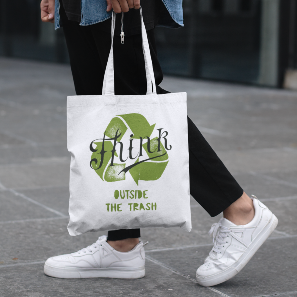 A white “Think outside the trash” tote bag.
