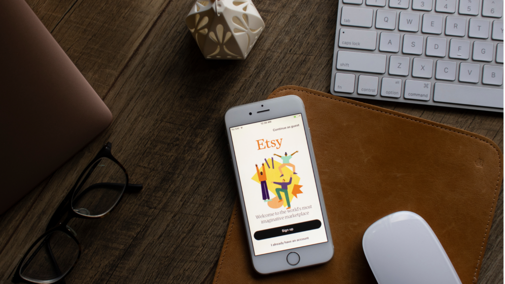 A mobile phone on a table with an Etsy application on it.