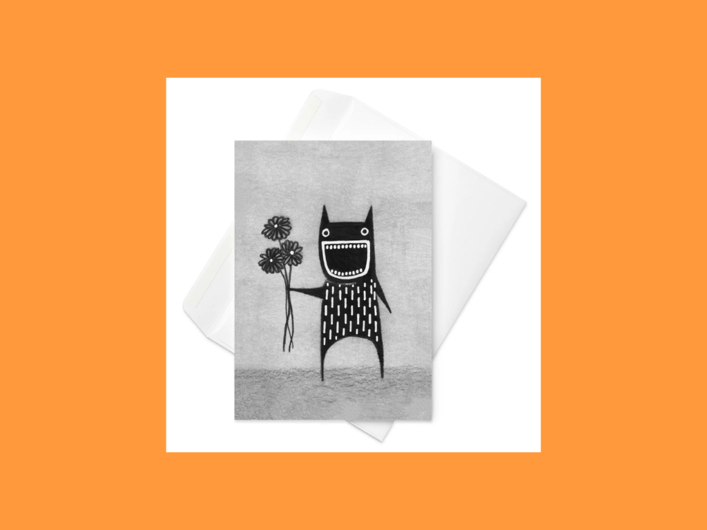 A greeting card with a black monster holding flowers painted on it.