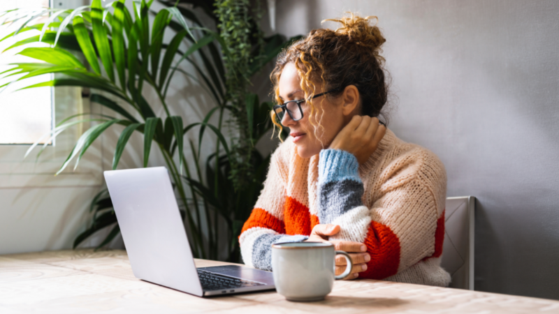 A woman is working on her laptop