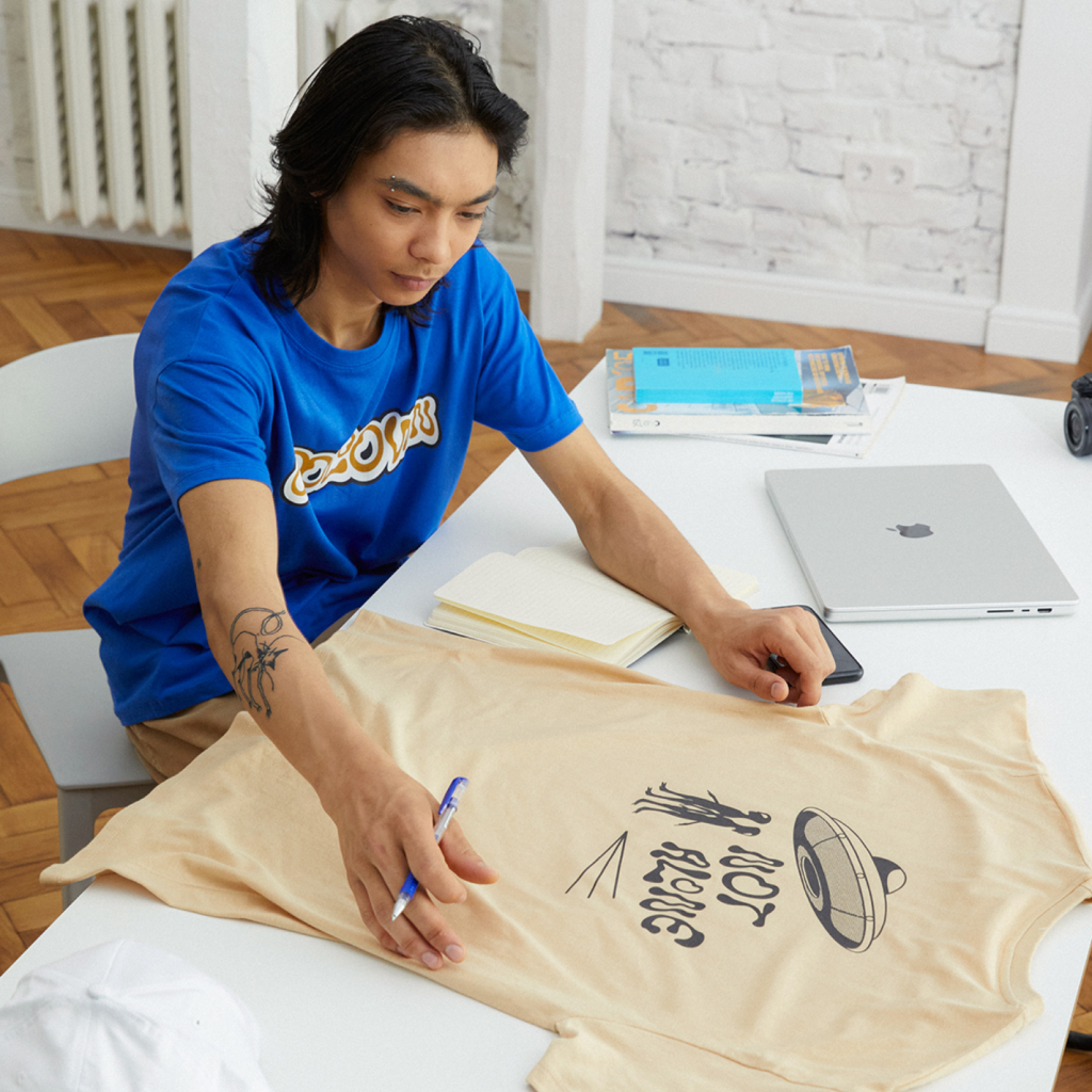 A person checking t-shirt design.