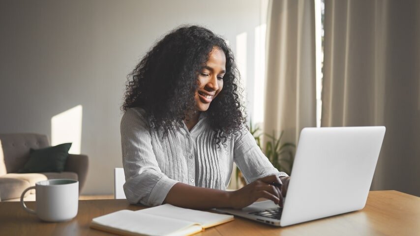 Woman working on her affiliate marketing campaign on her laptop.