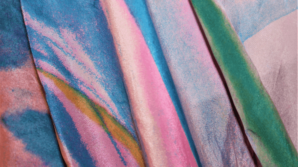 Close-up of vibrant tie-dyed fabric showcasing a swirl of colors in a unique pattern.