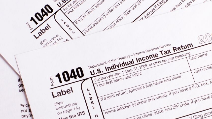 A pile of 1040 U.S. Individual Income Tax Return forms.
