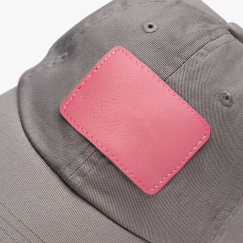 A woman wearing a dark custom cap with a logo.