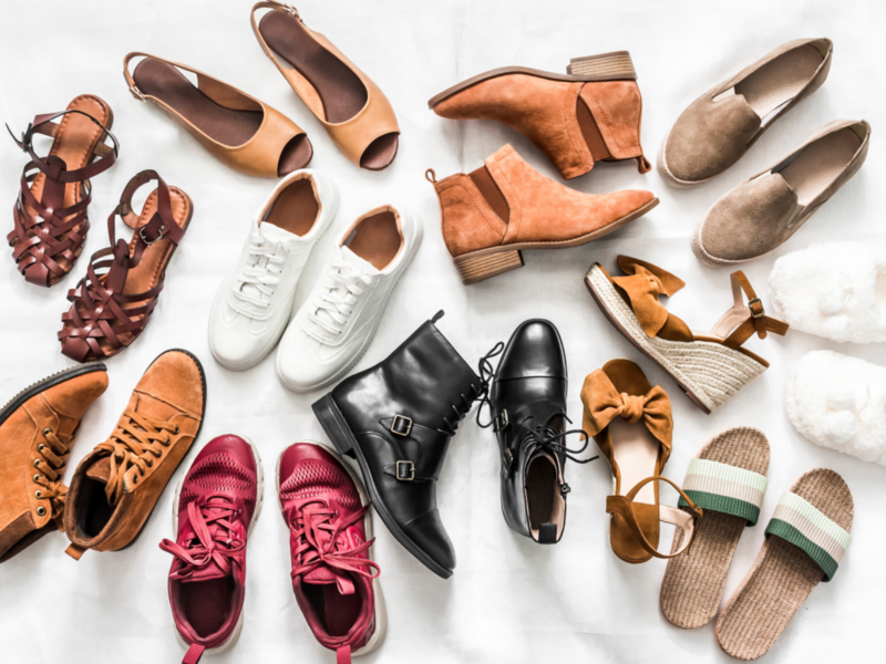 Various styles of women's shoes arranged on a bright white background.