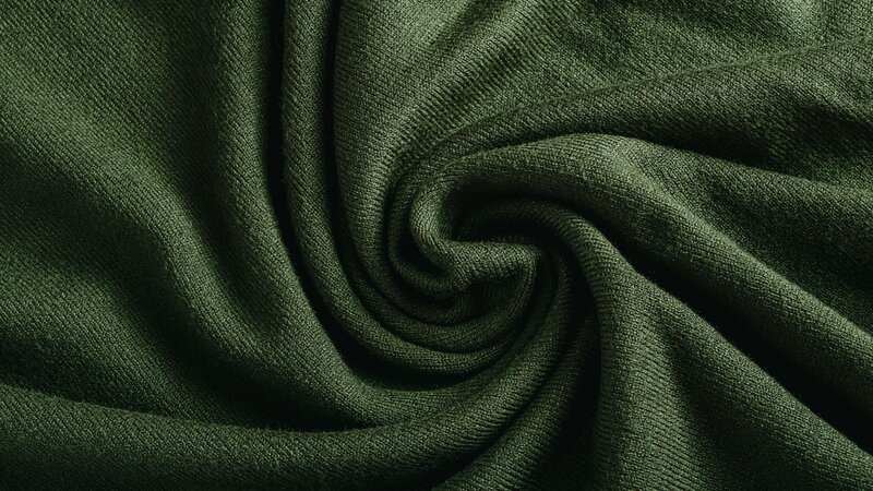 A person gently cradles soft cotton in their hands, showcasing its fluffy texture and natural beauty.