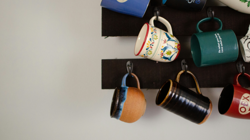 A wall-mounted display showcasing an array of colorful coffee mugs arranged neatly for visual appeal.