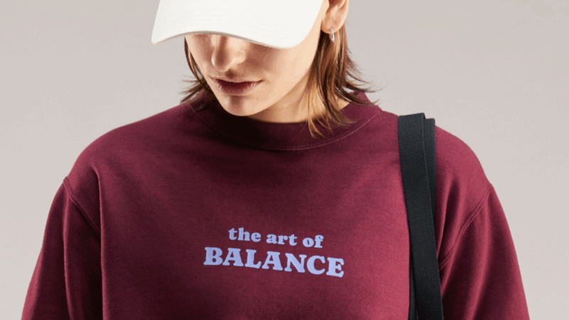 Sweatshirt featuring the phrase "The Art of Balance" in stylish typography on a neutral background.