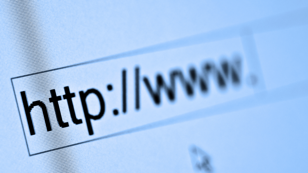 A person typing the initial part of a website URL, “https://www.”.