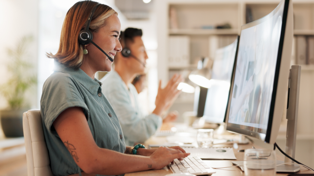 A smiling woman working as a customer service specialist.