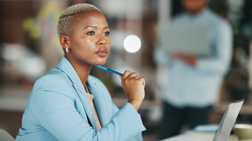 A businesswoman looking thoughtfully into the distance.