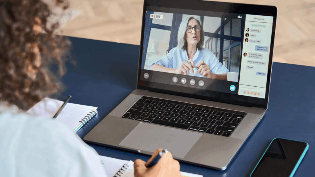 A woman is learning online using a laptop.