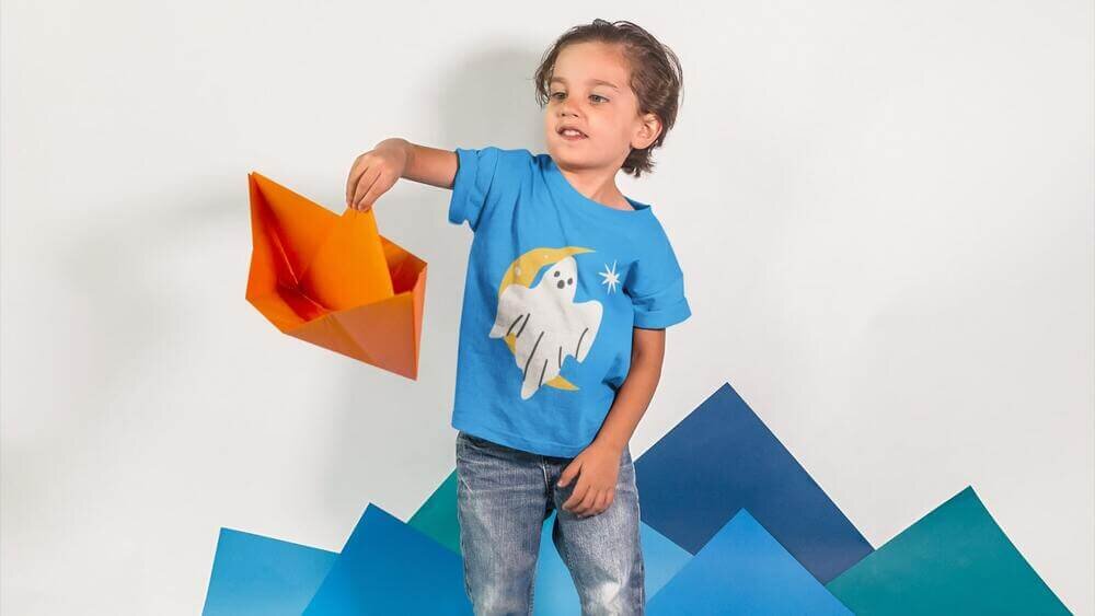 A toddler wearing a custom blue Gildan 64500P t-shirt with an illustration of a ghost.