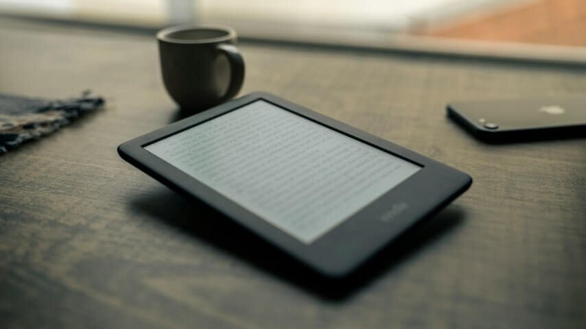 A Kindle device on the table.