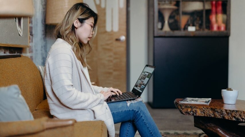 A woman researching about how comparing Etsy Views vs Visits can help increase sales.