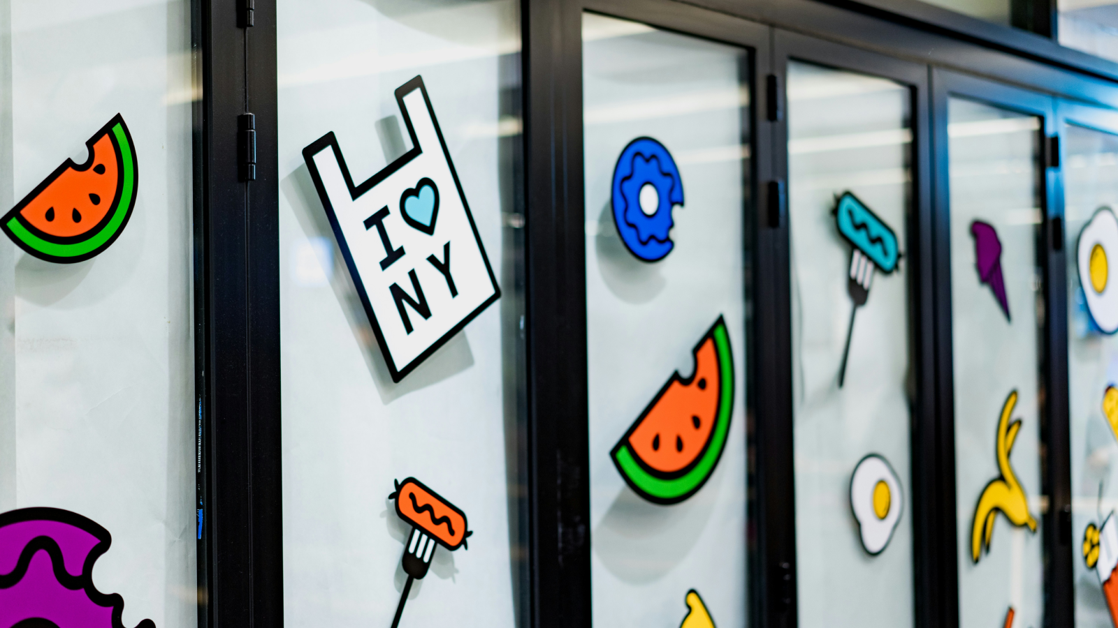 A glass window wall with different stickers on the glass.