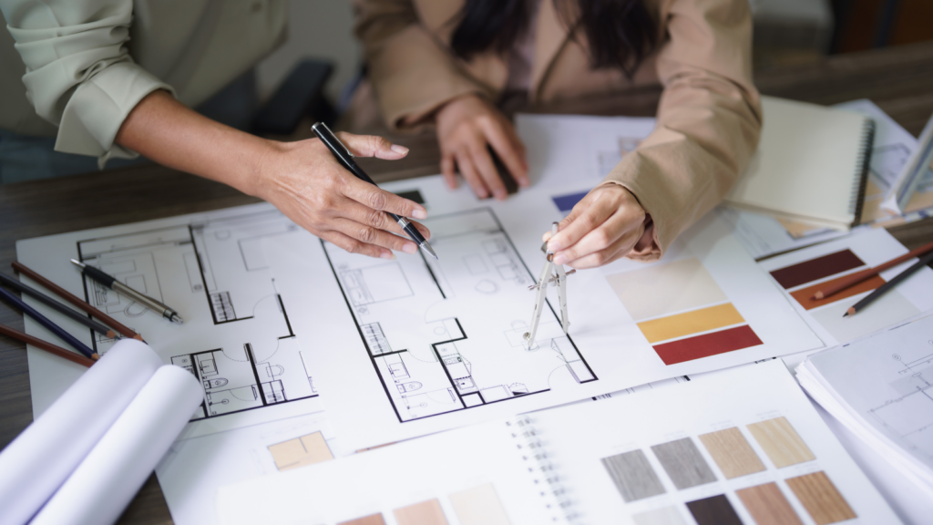 Two women preparing interior design plans.