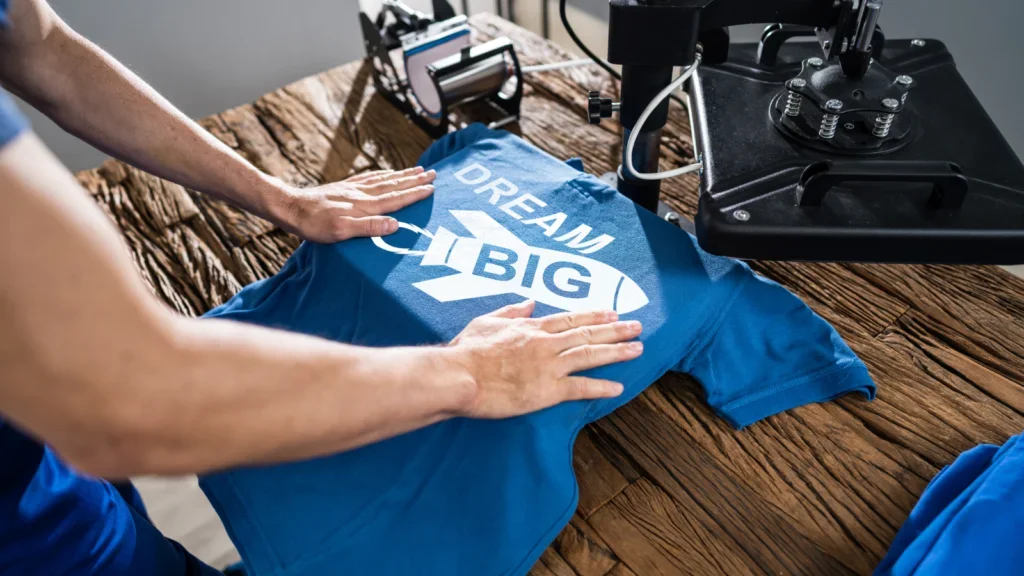 Person printing a print on a t-shirt.