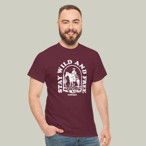 A man wearing a maroon and white “Stay wild and free” t-shirt on a light olive green background.