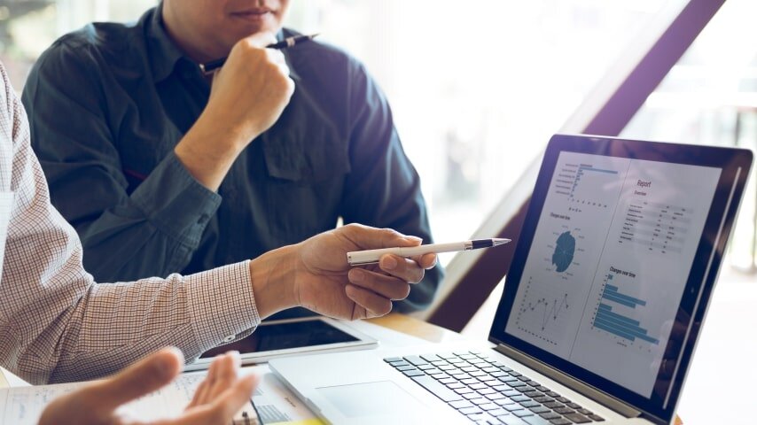 Two affiliate marketers analyzing their marketing performance data.