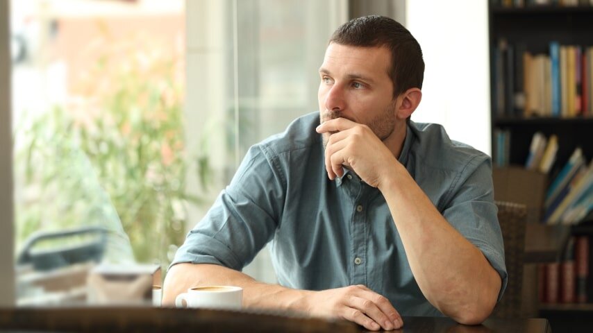 A man looking to the side and thinking.